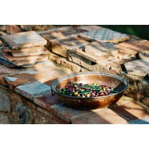 Fotografie Olive fruits in container kept on paving stones, andersdahl65, 40x26.7 cm