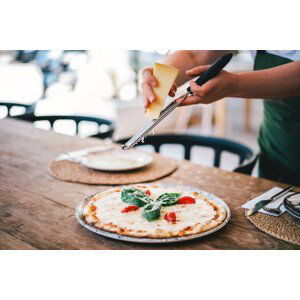 Fotografie An Italian chef generously grating cheddar, Yana Iskayeva, 40x26.7 cm